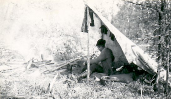 Fred Darbyshire under lean-to camp