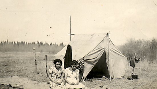 Two ladies in front of a tent