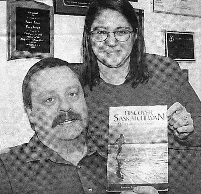 Michael and Anna Clancy with Discover Saskatchewan Book.