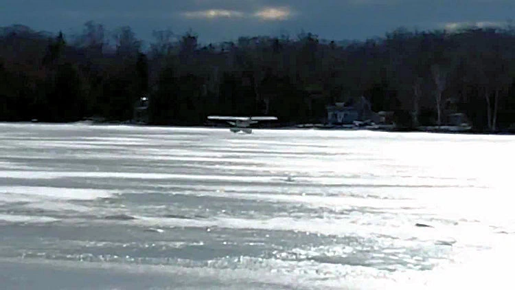 Plane landing on ice with pontoonss.